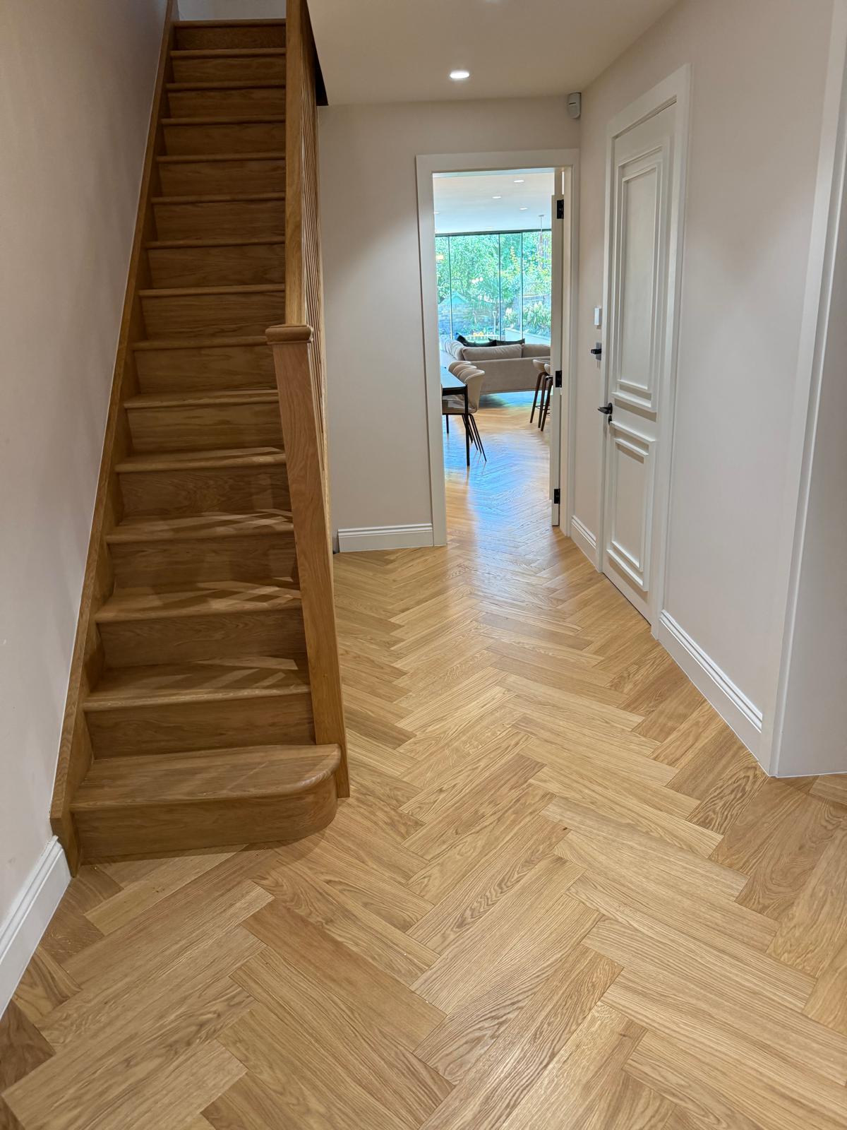Herringbone floor hallway with staircase
